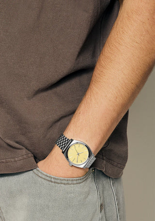 Nixon Time Teller Silver/Butter analog watch with stainless steel bracelet and soft butter-yellow dial.