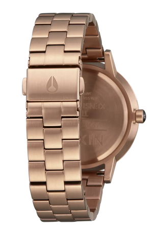 Nixon Kensington Watch in Rose Gold with Olive Sunray dial, engraved indices, and stainless steel bracelet.