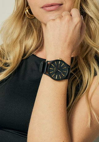 Nixon Sentry Leather Matte Black/Gold watch with black leather strap and gold-accented analog dial.
