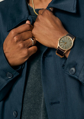 Nixon Sentry Leather Rose Gold/Gunmetal/Brown watch with brown leather strap and gunmetal analog dial.