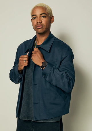 Nixon Porter Leather All Black/Gold analog watch with black leather strap and gold-accented black dial.