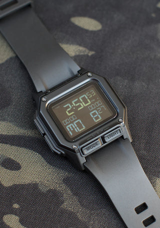 Nixon Regulus All Black digital watch with high-contrast LCD display and black TPU strap.