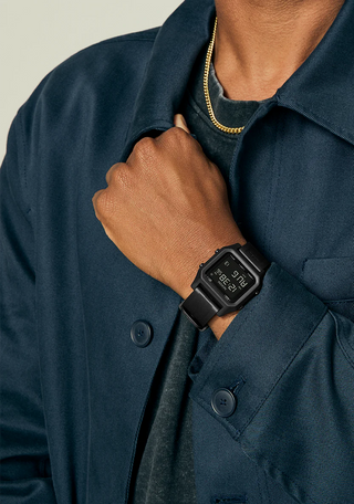 Nixon Staple All Black digital watch with recycled plastic case, high-contrast LCD, and black rubber-blend strap.