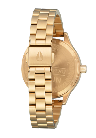 Nixon Optimist Watch in All Light Gold, featuring geometric details, solar cell technology, and a stainless steel bracelet.