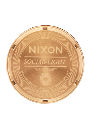 Nixon Optimist Watch in All Light Gold, featuring geometric details, solar cell technology, and a stainless steel bracelet.