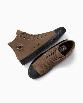 Brown high-top sneakers with black soles on a white background