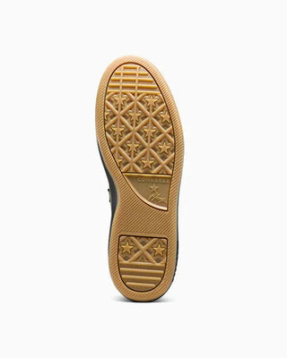 Close-up of a brown shoe sole with star pattern on a white background