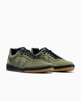Pair of green sneakers with black accents on a white background