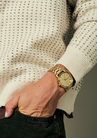 Nixon Sentry Wobble Watch in All Gold — 42mm stainless steel case with unique bent wobble design, Miyota quartz movement, hardened mineral crystal, lume hands, and quick-release bracelet