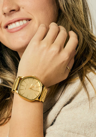 Nixon Sentry Wobble Watch in All Gold — 42mm stainless steel case with unique bent wobble design, Miyota quartz movement, hardened mineral crystal, lume hands, and quick-release bracelet