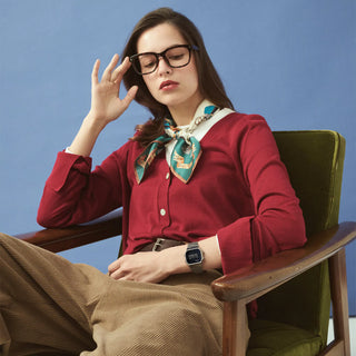 Woman in a red outfit with a green chair and blue background