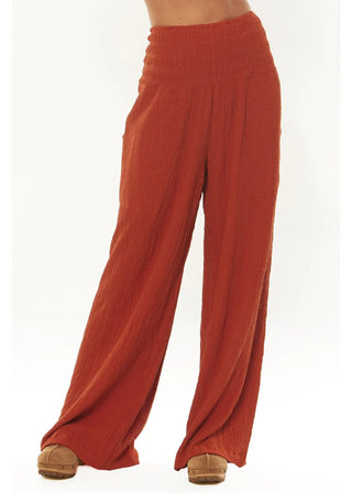 Woman in chic Fala Woven Pant in Tuscan Sun with smocked waist, reflecting luxe loungewear style.