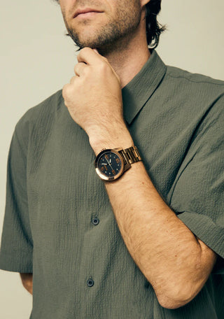Nixon Corporal Chocolate/Dark Roast analog watch with stainless steel bracelet and rugged brown field-style dial.