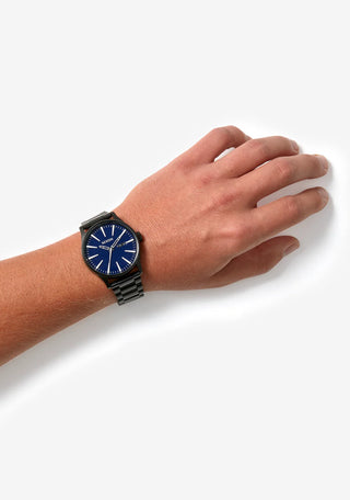 Nixon Sentry Blue Sunray analog watch with stainless steel bracelet and textured blue sunray dial.
