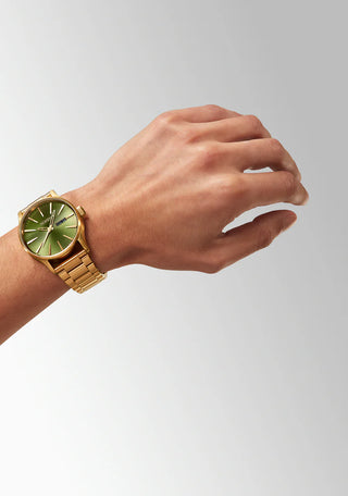 Nixon Sentry Gold/Green Sunray analog watch with gold stainless steel bracelet and green sunray dial.