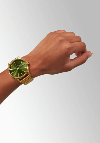 Nixon Sentry Gold/Green Sunray analog watch with gold stainless steel bracelet and green sunray dial.
