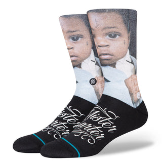Image: A pair of black crew socks with a Lil Wayne x Stance Mister Carter design.