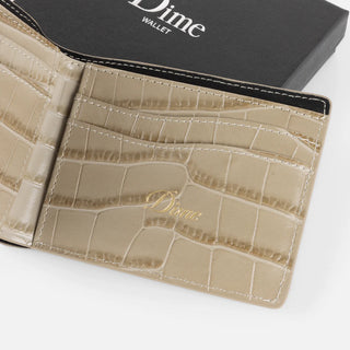 Tan croc-embossed Dime bifold wallet with slim profile and stitched edges.