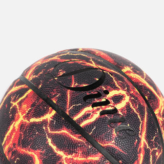 Basketball with fiery design and visible brand logo on a light gray background