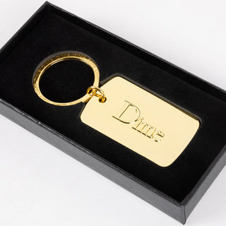 Gold keychain with 'Dime' engraving in a black box