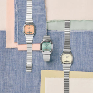 Casio Vintage AQ240E-2A watch with silver bracelet, light blue sunray dial, and analog-digital display.