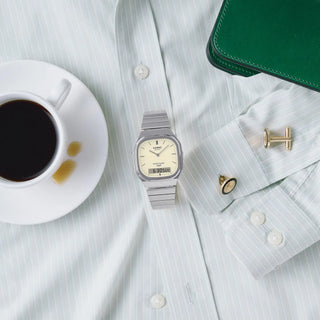 Casio Vintage AQ240E-7A2 watch with silver bracelet, white matte dial, and analog-digital display.