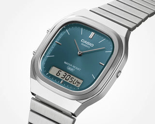 Casio watch with blue dial and silver metal strap on a white background