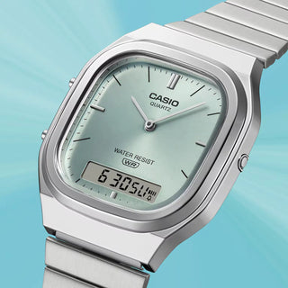 Casio Vintage AQ240E-2A watch with silver bracelet, light blue sunray dial, and analog-digital display.