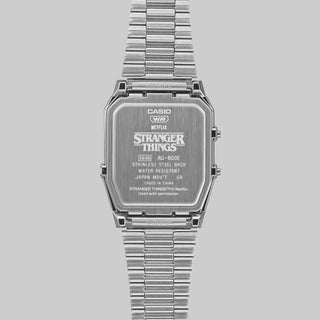 Silver Casio watch with 'Stranger Things' branding on a gray background
