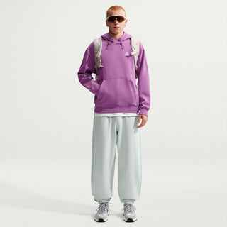 Nike ACG Tuff Fleece pullover hoodie in Monarch Purple with a white chest logo, adjustable hood cords, and a kangaroo pocket.