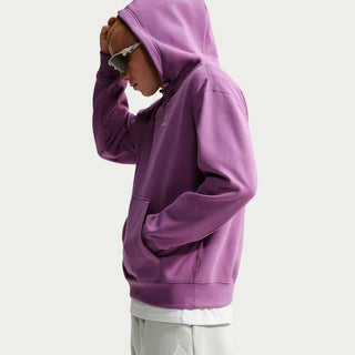 Nike ACG Tuff Fleece pullover hoodie in Monarch Purple with a white chest logo, adjustable hood cords, and a kangaroo pocket.