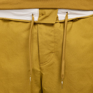 Nike SB Kearny cargo skate pants in Bronzine, durable ripstop fabric, six pockets, drawcord waist.