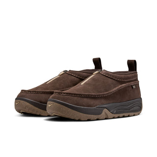 Nike ACG Izy in Baroque Brown/Sanddrift Velvet with moccasin-inspired styling, contrast stitching, zipper closure, and a rugged rubber outsole.