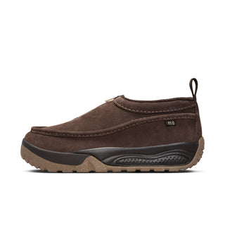 Nike ACG Izy in Baroque Brown/Sanddrift Velvet with moccasin-inspired styling, contrast stitching, zipper closure, and a rugged rubber outsole.