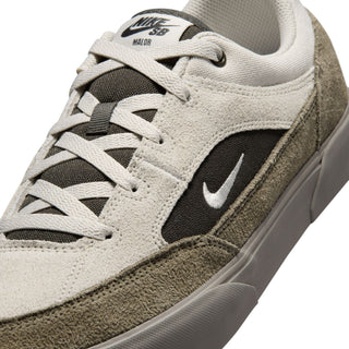 Nike SB Malor Skate Shoes in Light Bone/Light Army— vulcanized skate shoe with suede and canvas upper, extended toe bumper, cushioned collar, and herringbone grip outsole built for entry-level skaters.

