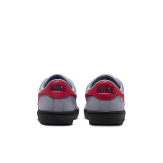 Rear view of Nike SB Tennis Classic shoes featuring red heel tabs with black Nike branding and grey suede uppers.