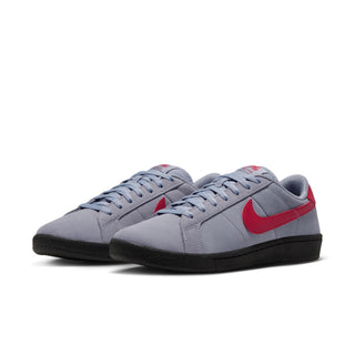Three-quarter view of Nike SB Tennis Classic shoes showing grey suede uppers, red Swooshes and black rubber soles.