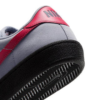 Close-up of Nike SB Tennis Classic Stealth/Gym Red-Black showing red heel branding, grey suede and black herringbone outsole.