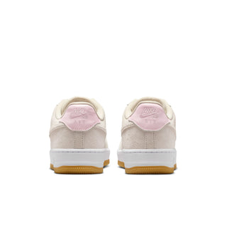 Beige sneakers with pink accents on a white background