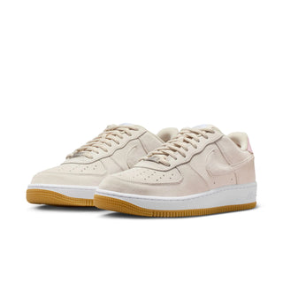 Beige sneakers with white soles on a white background