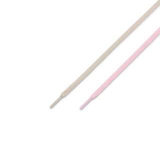 Two shoelaces, one beige and one pink, on a white background