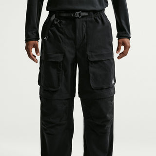 Model wearing black Nike ACG Smith Summit Zip Cargo Pants with a loose fit, large thigh cargo pockets, and zip-off leg panels

