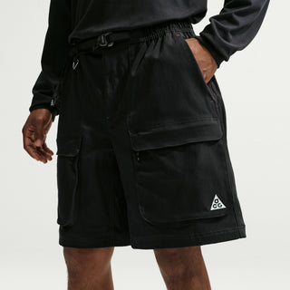 Model wearing black Nike ACG Smith Summit Zip Cargo Pants with a loose fit, large thigh cargo pockets, and zip-off leg panels

