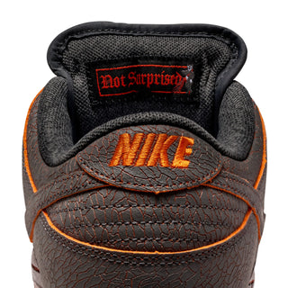 Nike SB Dunk Low Pro Premium Krampus in crackled grey leather with orange underlays.