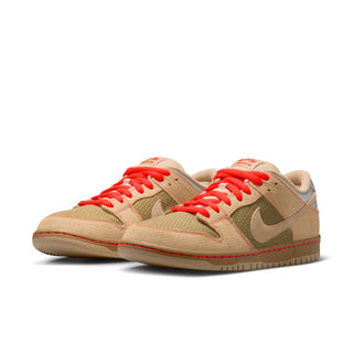 Beige sneakers with red laces on a white background