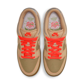 Pair of tan sneakers with red laces on a white background