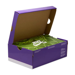 Open purple shoe box with green interior displaying Nike SB logo