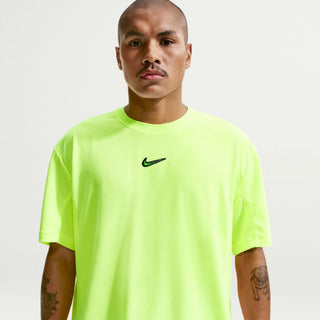 Person wearing a bright green Nike t-shirt with a white background