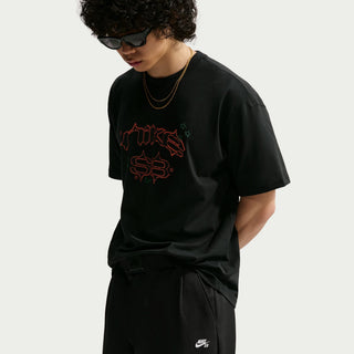 Rear view of a model wearing black Nike SB Men’s Skate Pants with a roomy, straight-leg silhouette