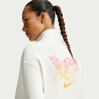 Woman wearing a white sweatshirt with a colorful graphic on the back against a light gray background